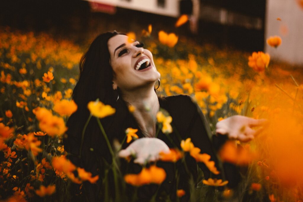 Do you feel lucky? Happy woman in orange celebrating life