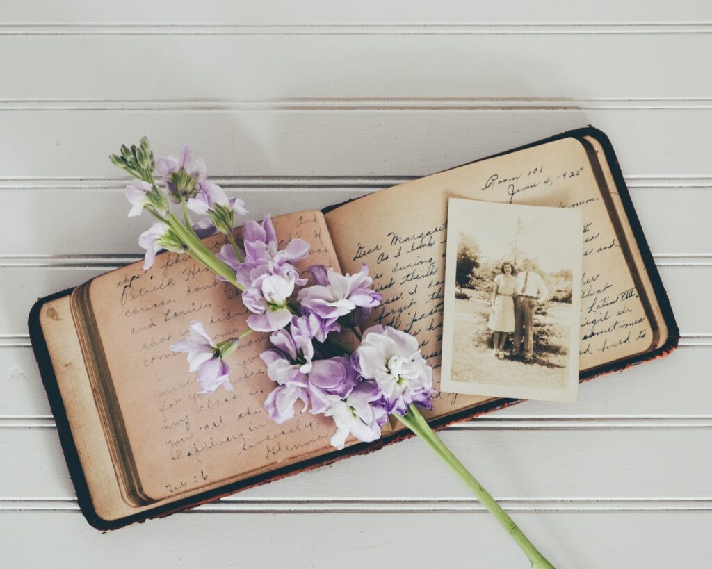 Old book and flowers - Photo by Debby Hudson on Unsplash